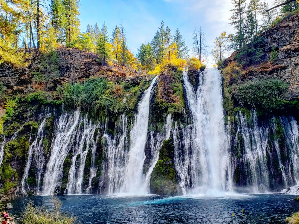 waterfalls on green and brown mountain during daytime