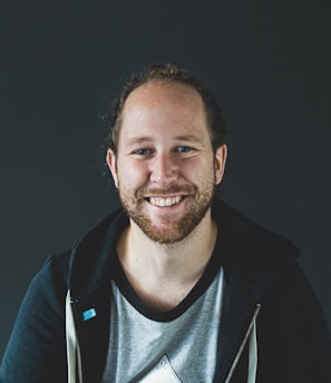 man in black jacket smiling