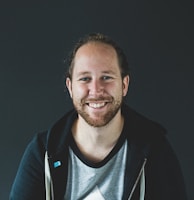 man in black jacket smiling