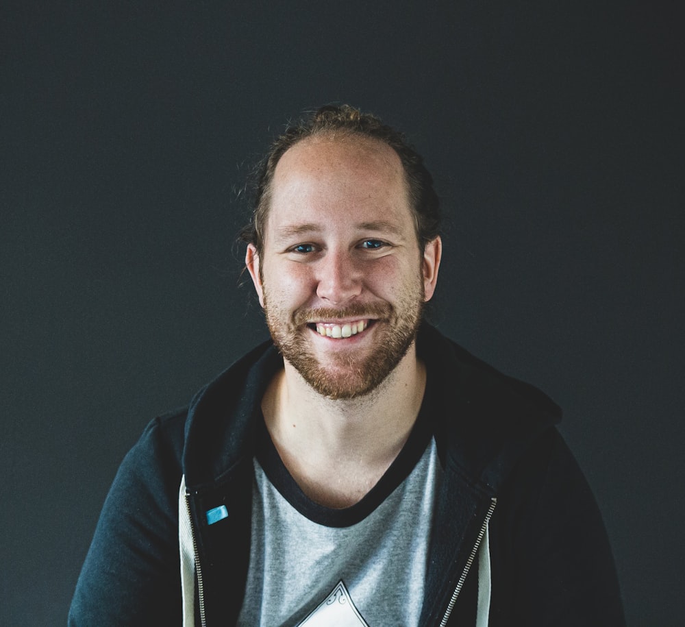 man in black jacket smiling