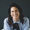 smiling woman in white and black checkered dress shirt