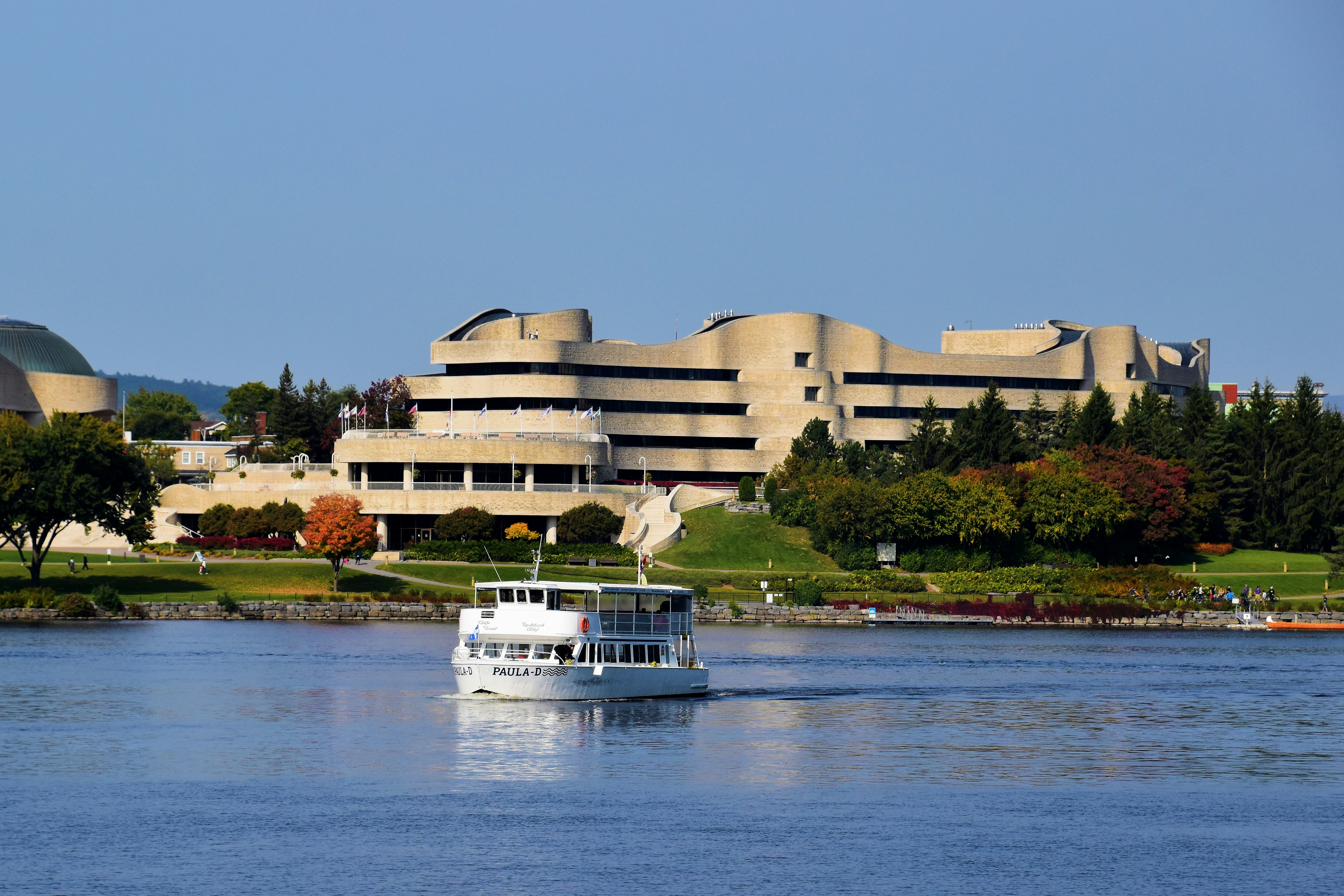 white boat on water near white building during daytime