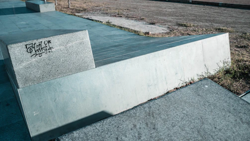 Sidewalk-adjacent exterior surface showing a smooth finish post graffiti removal.