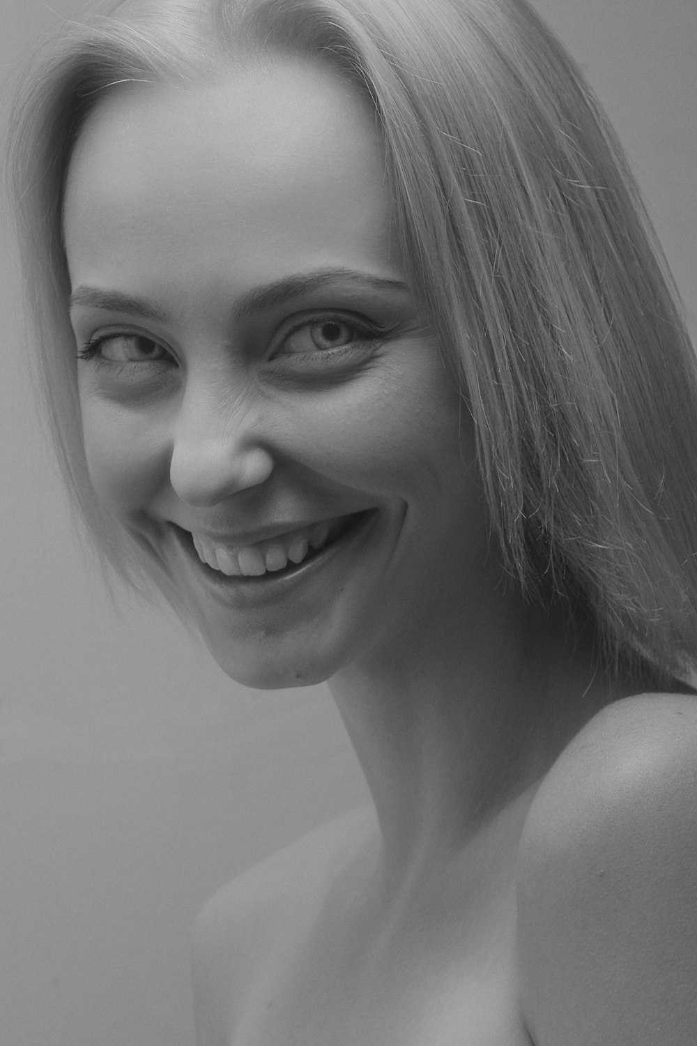 grayscale photo of woman smiling