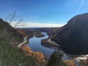 lake between mountains during daytime