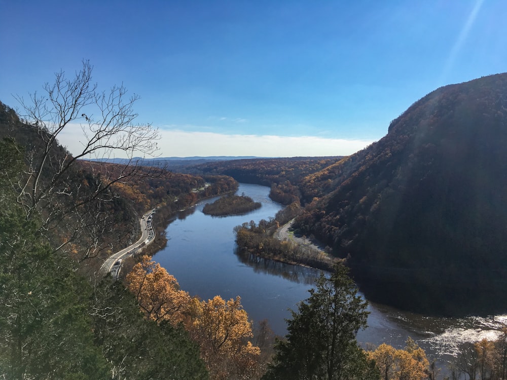 lake between mountains during daytime