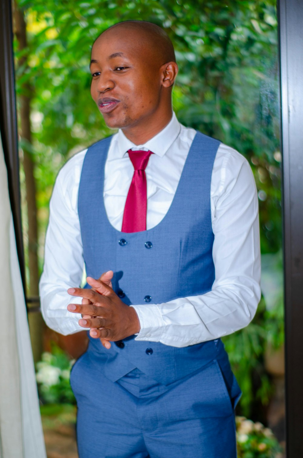 man in blue vest and white dress shirt