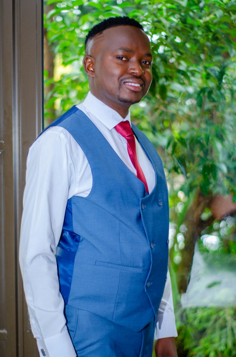 man in blue vest and white dress shirt