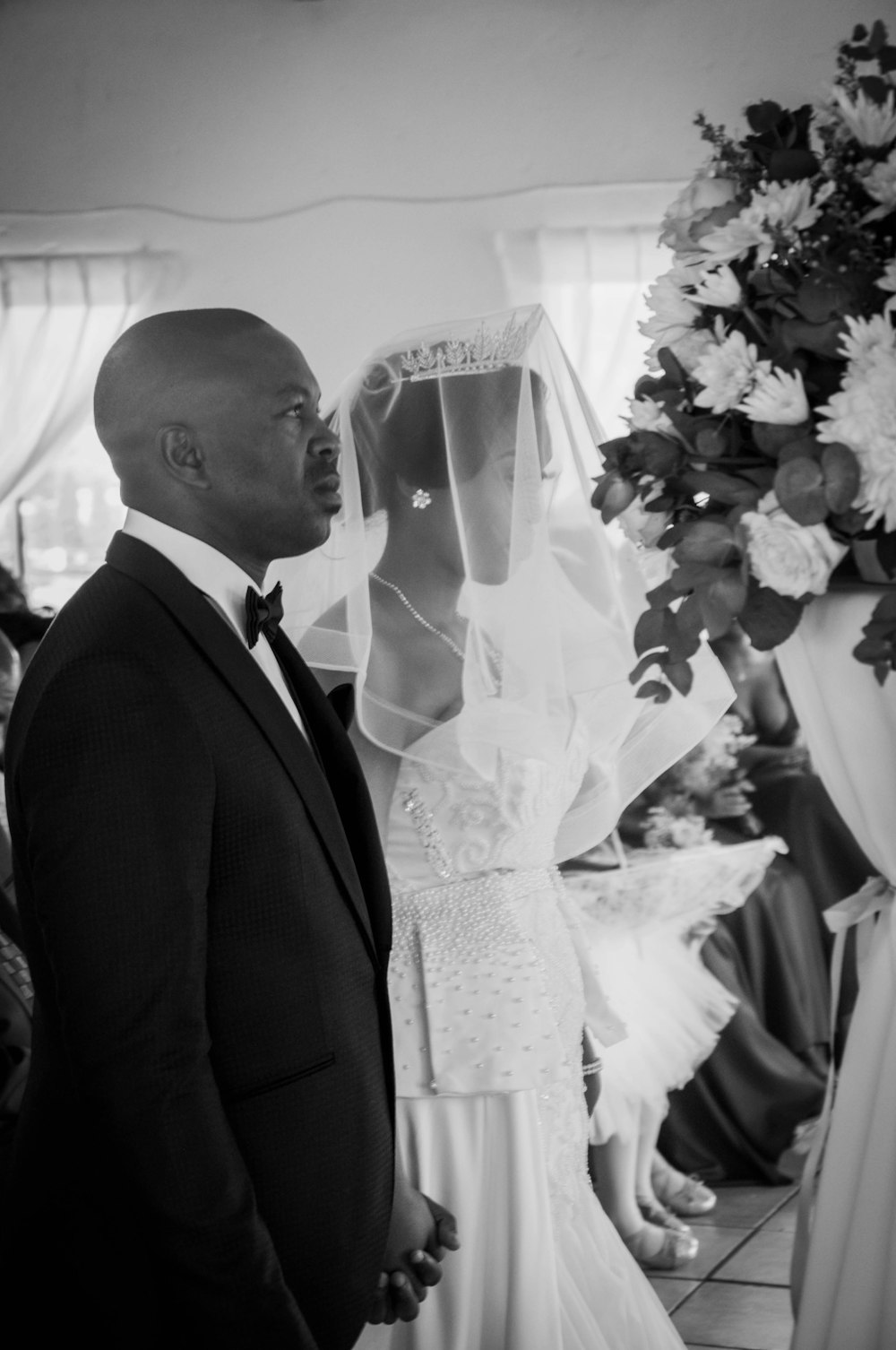 man in black suit jacket and woman in white wedding dress