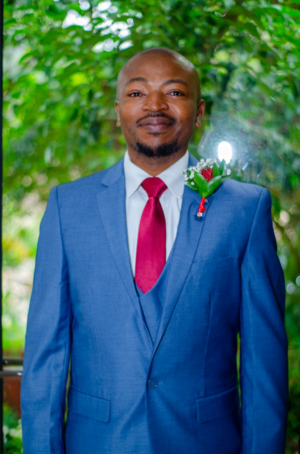 man in blue suit jacket smiling