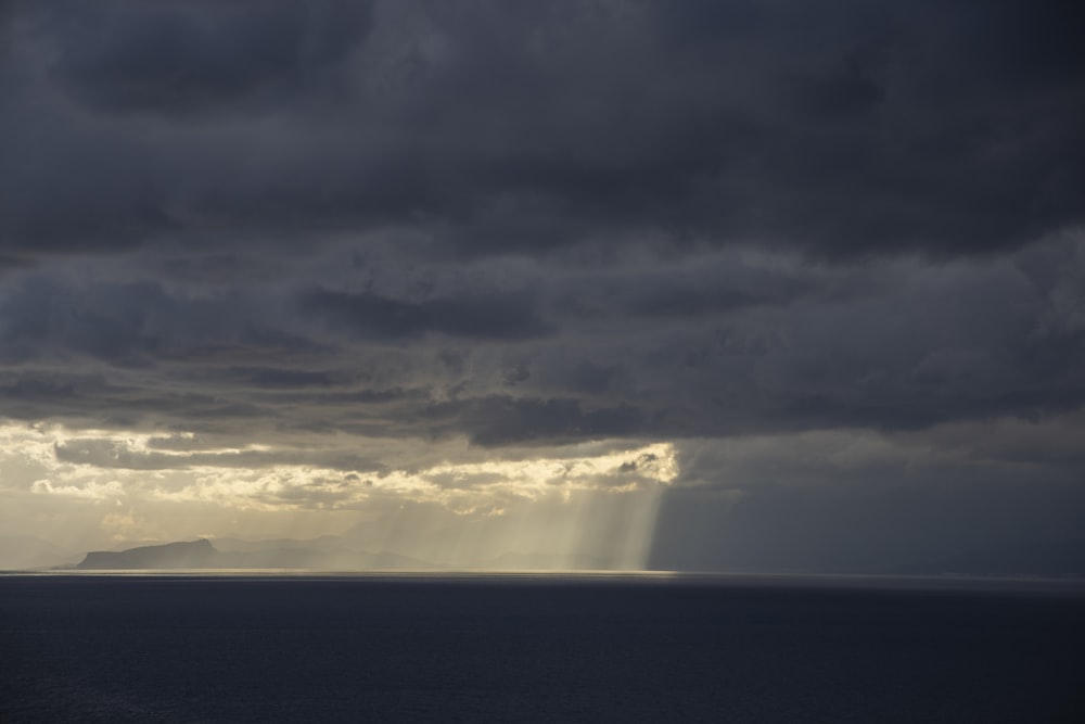 sea under cloudy sky during daytime