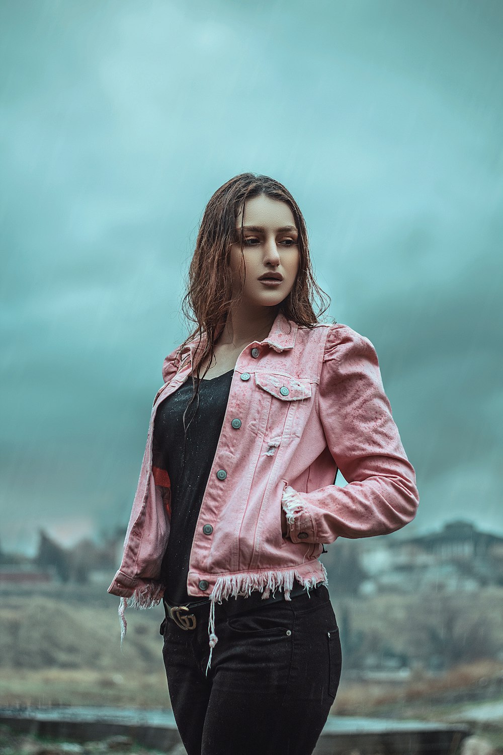 girl in pink denim jacket standing under white clouds during daytime