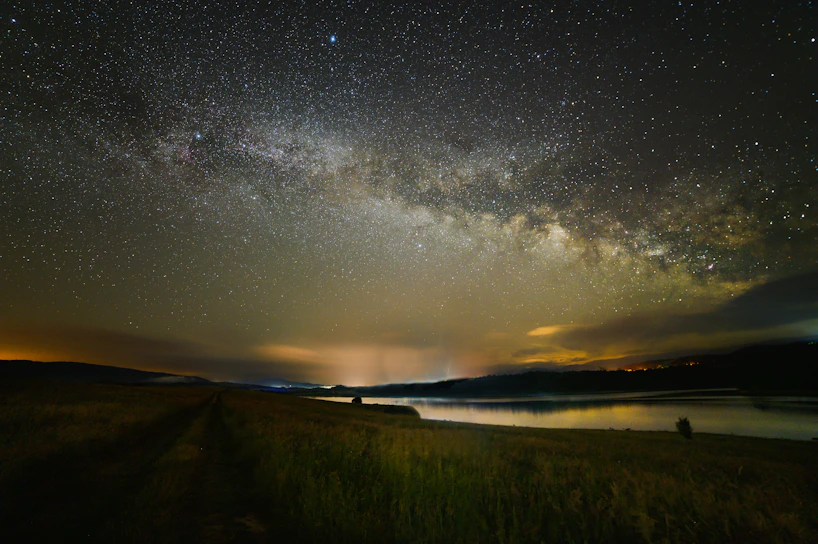 A breathtaking night sky filled with countless twinkling stars over a serene landscape.
