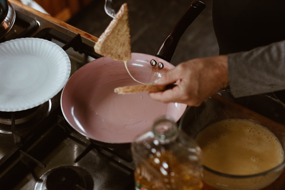 person holding stainless steel spoon