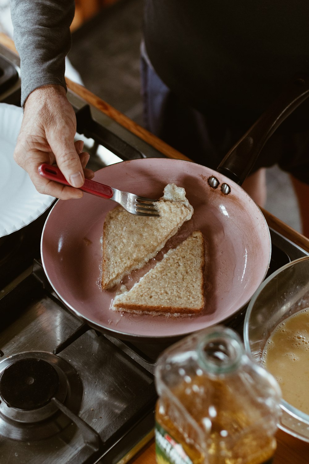 person holding stainless steel fork and bread knife