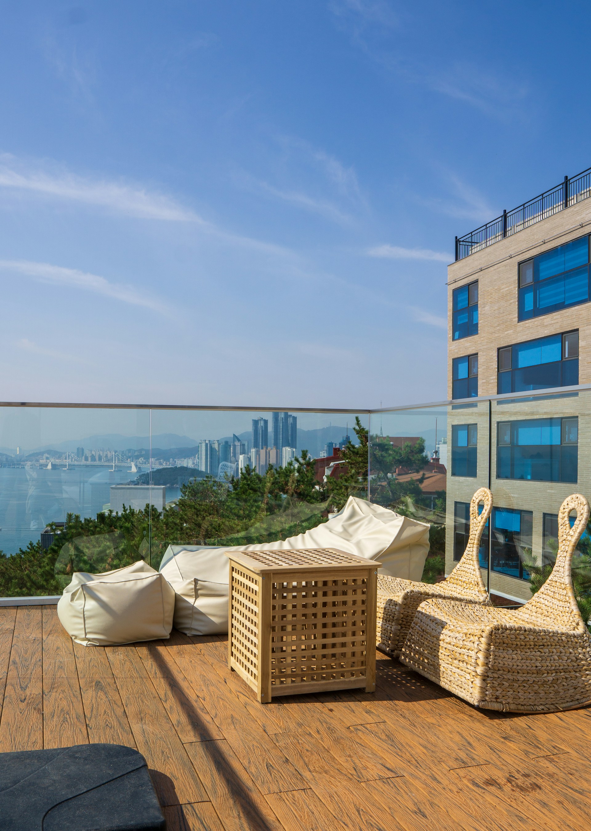 A panoramic view of a stylish Airbnb apartment balcony overlooking the London skyline, perfect for a relaxing stay.