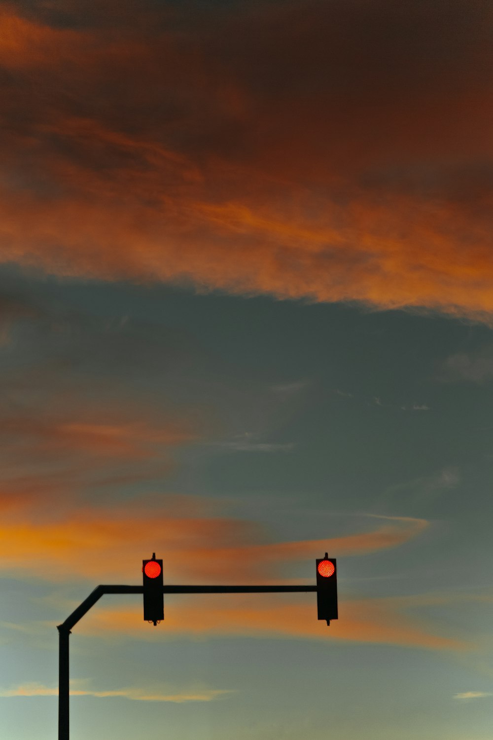 silhouette of person standing on top of building during sunset