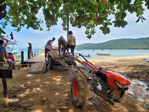Group of African security consultants collaborating outdoors near a port facility.