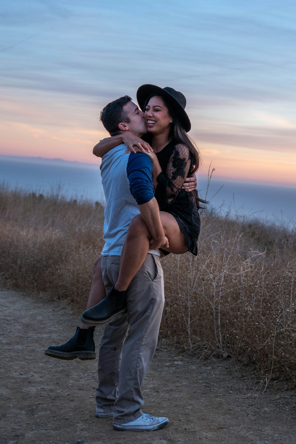 man carrying woman on his back