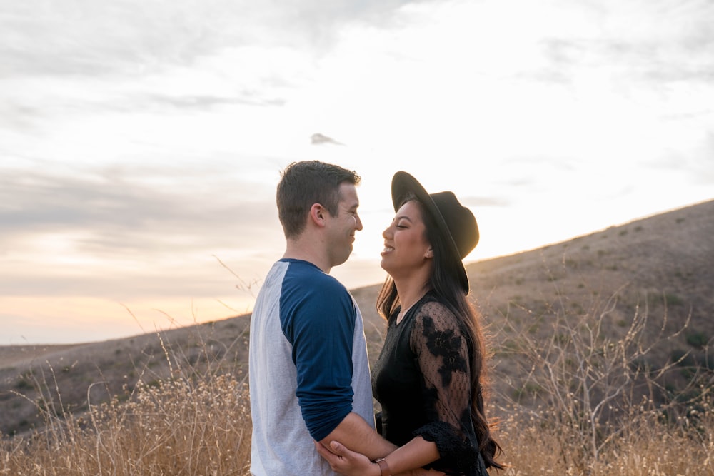 man in blue long sleeve shirt and woman in black and brown floral dress