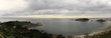 A panoramic view of Donegal coastline under a cloudy sky with gentle rain