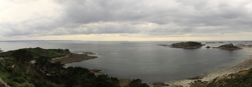 A panoramic view of Donegal coastline under a cloudy sky with gentle rain