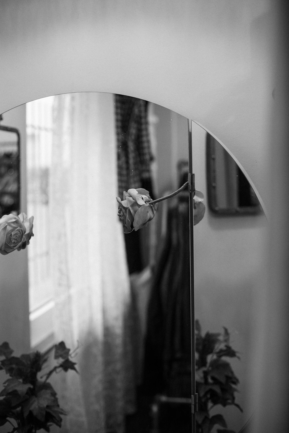 grayscale photo of woman in wedding dress holding flowers