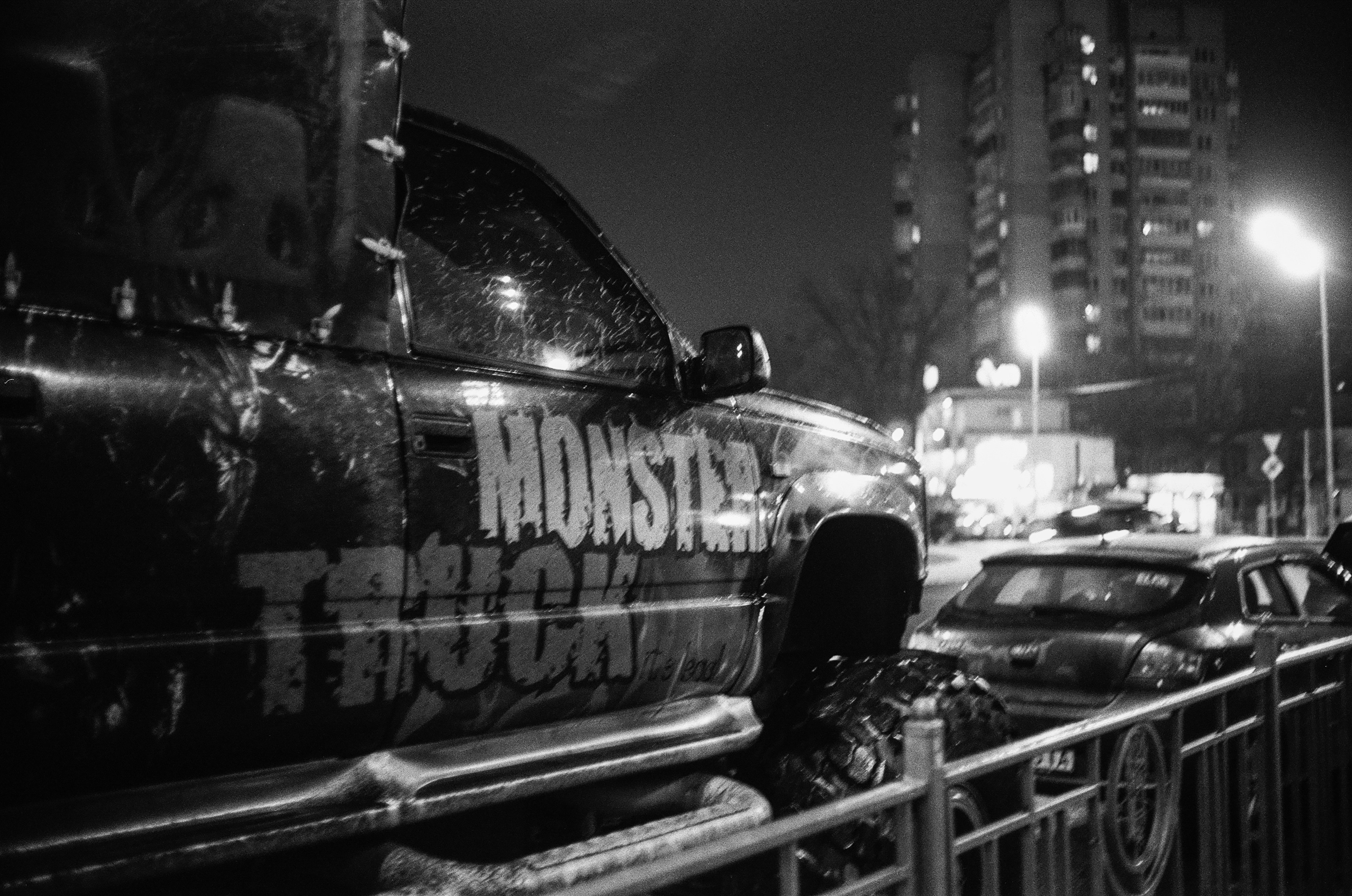 grayscale photo of car in the city