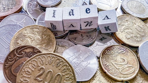 silver round coins on white box