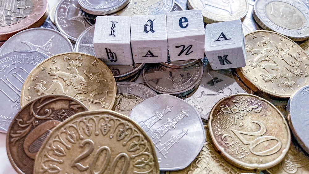 silver round coins on white box