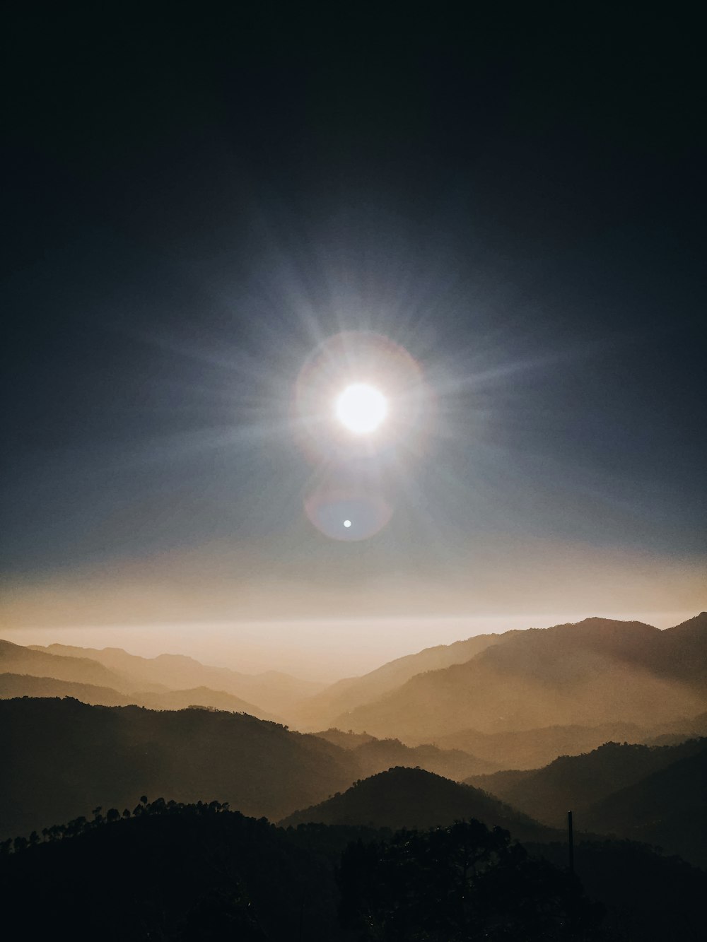 sun over the mountains during daytime