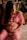 woman in pink dress sitting on brown wooden chair