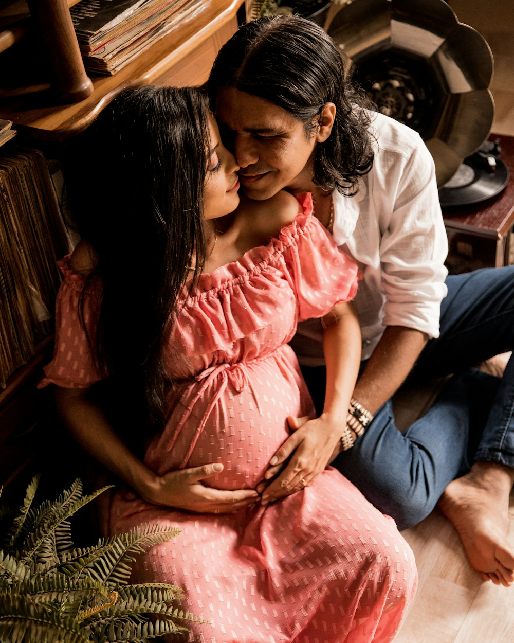 woman in pink dress sitting beside man in white shirt