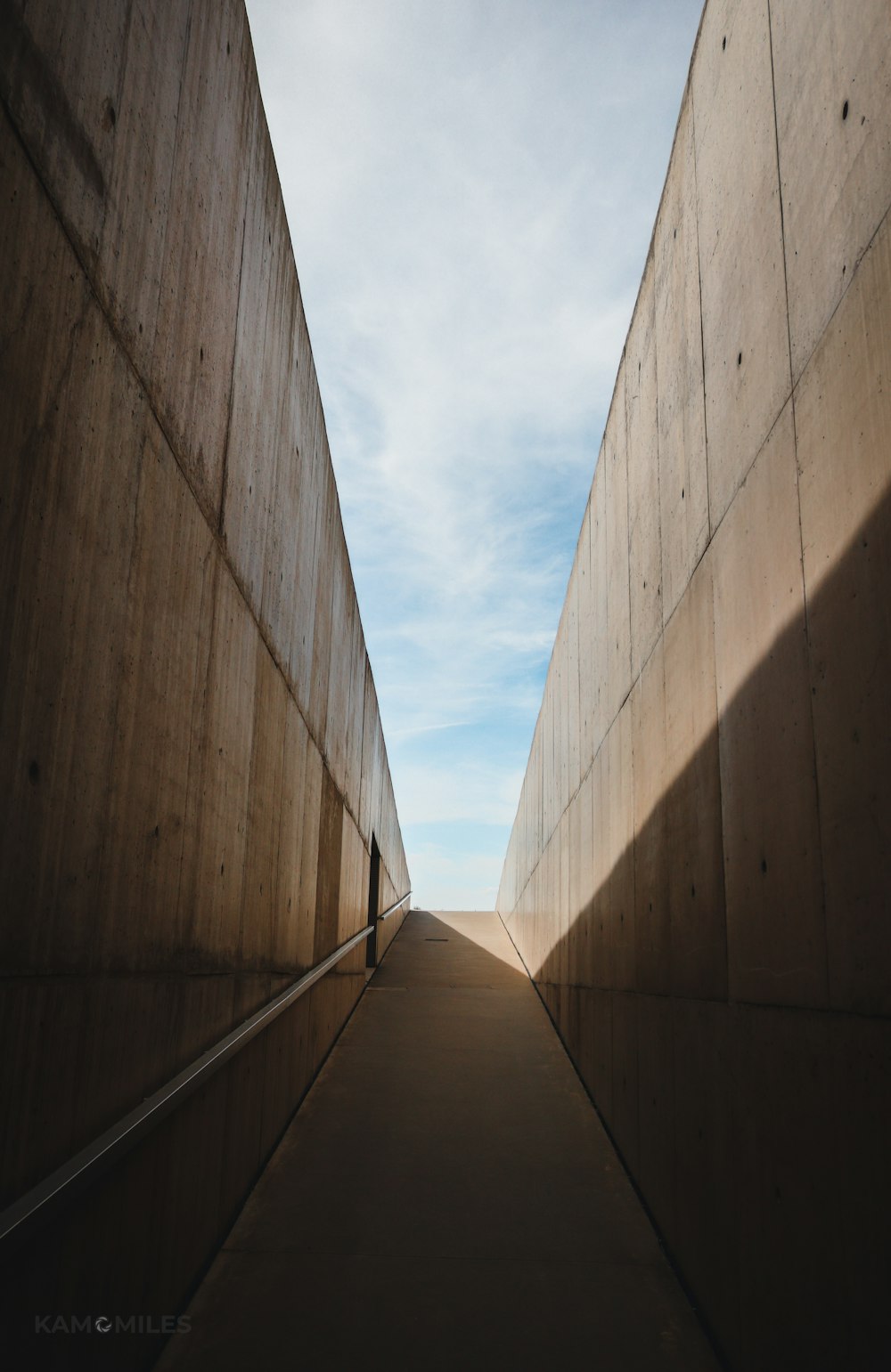 low angle photography of brown concrete building under white clouds during daytime