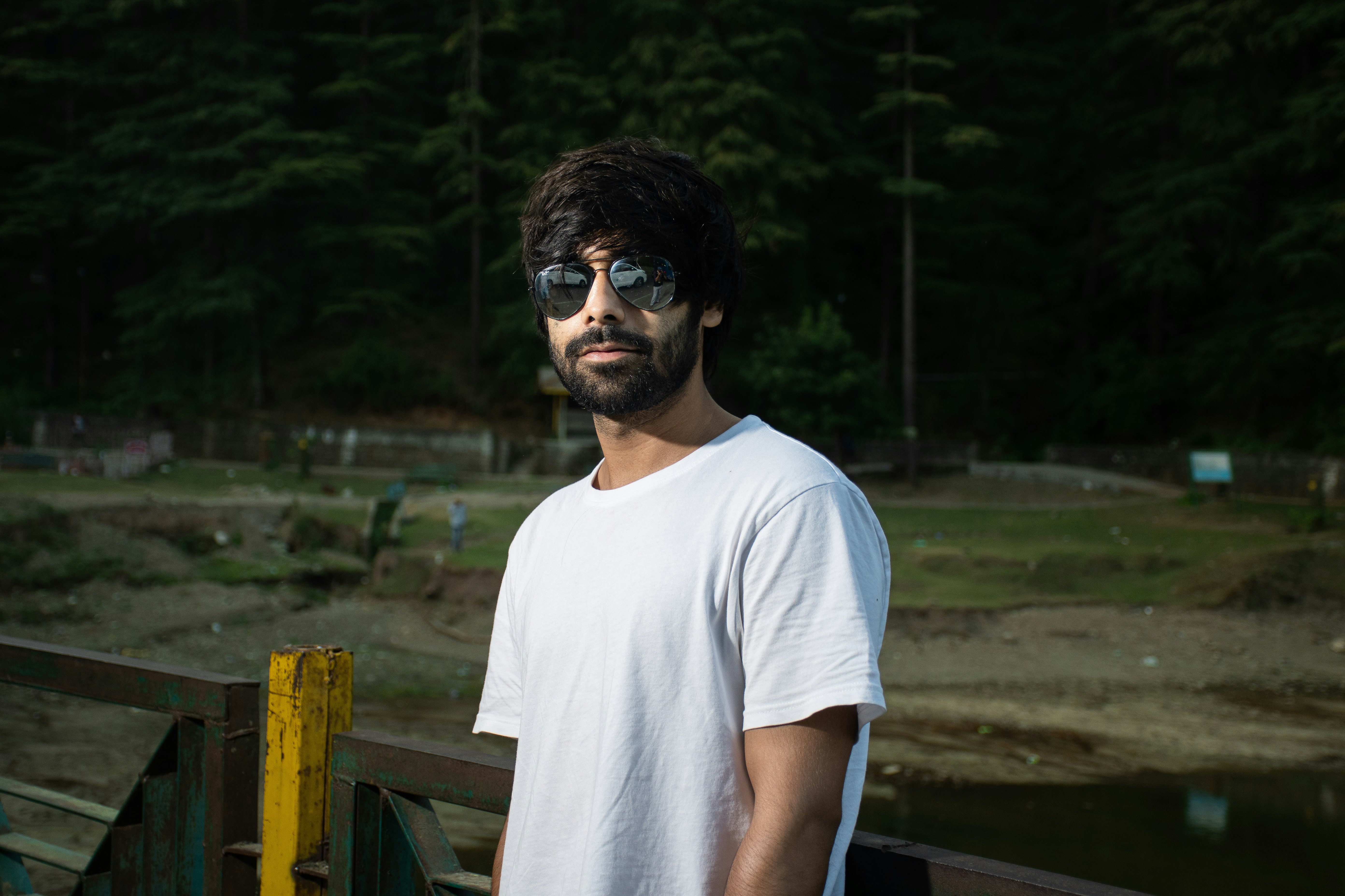 man in white crew neck t-shirt wearing black sunglasses