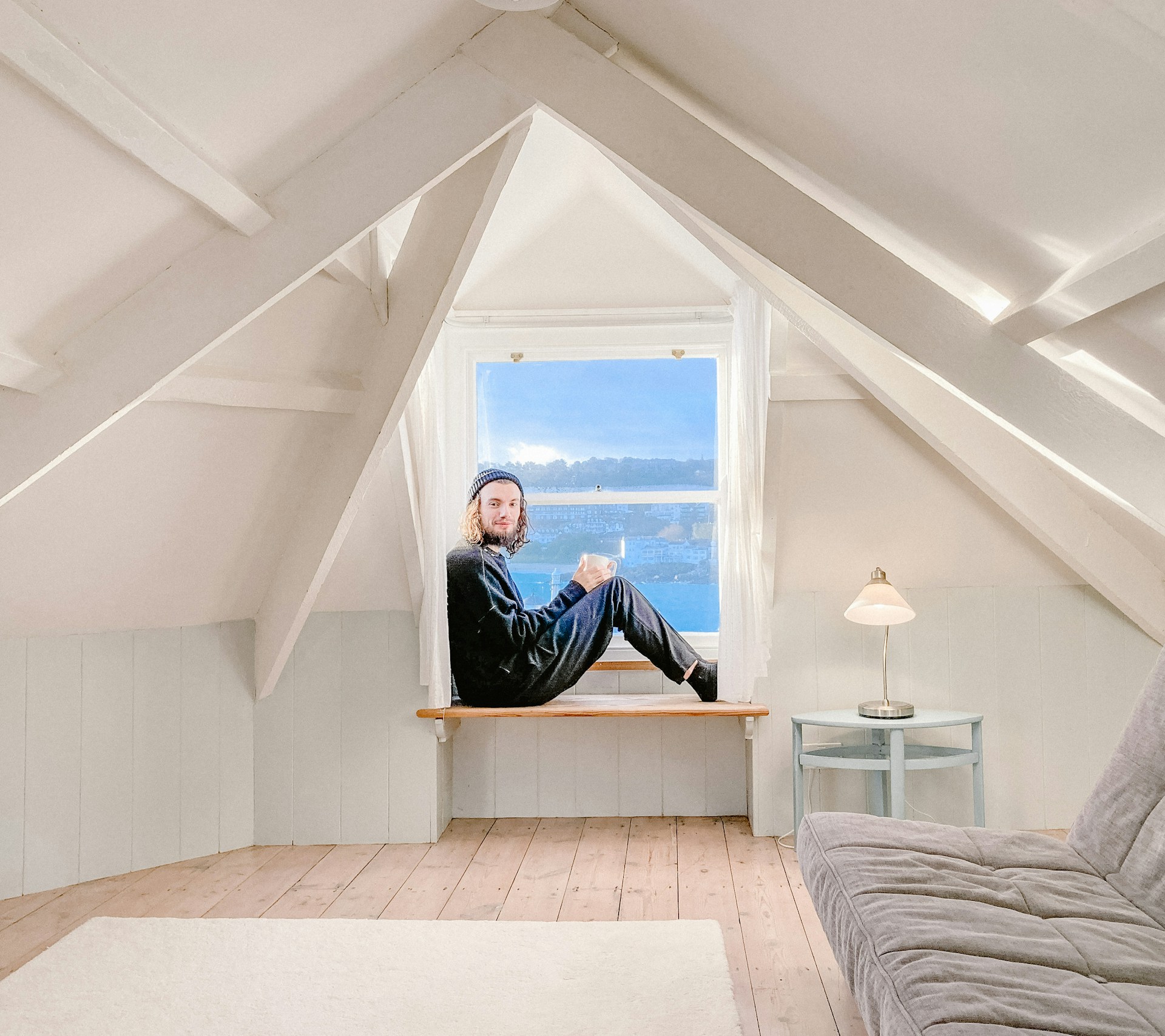man in black jacket sitting on bed