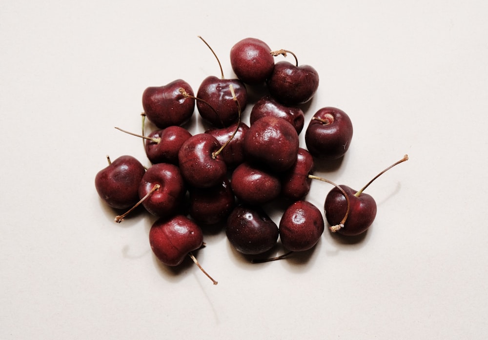 red cherries on white surface