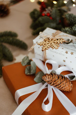 A beautifully wrapped thoughtful gift box on a wooden table inside a cozy store corner