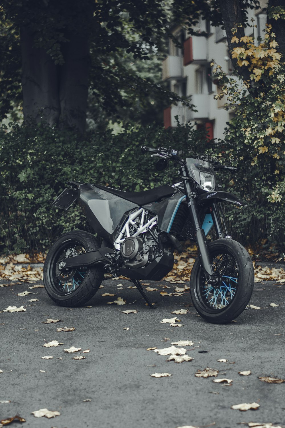 blue and black sports bike parked on gray concrete road during daytime