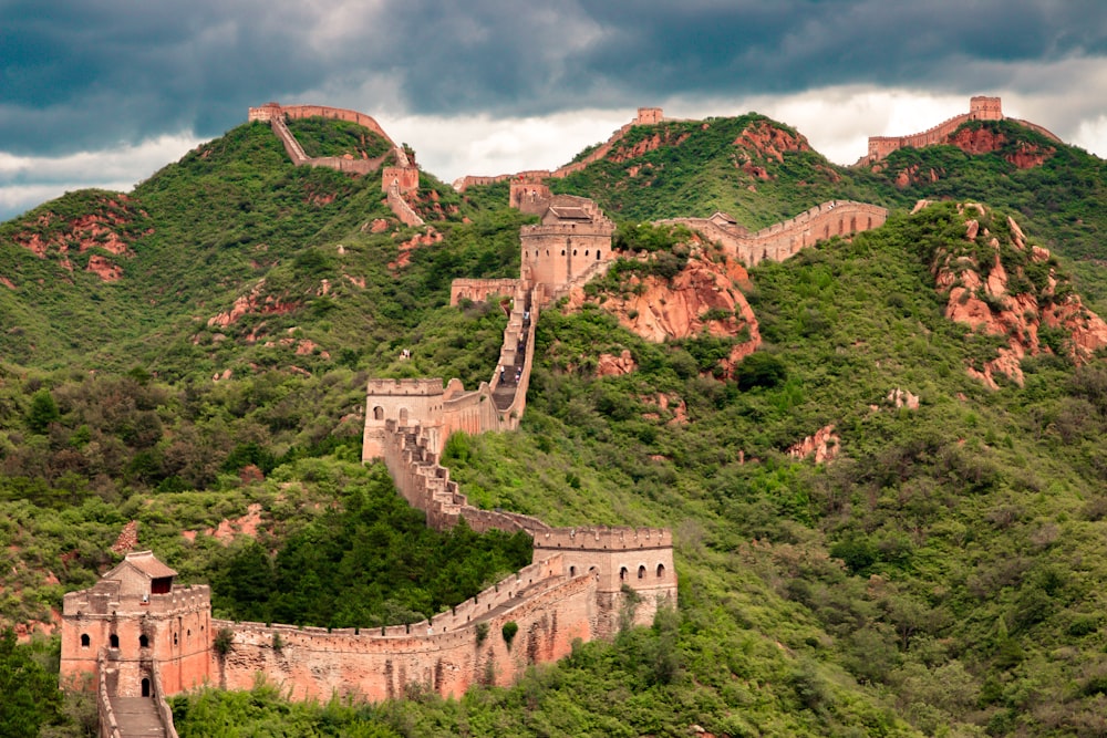 A snapshot of the Great Wall of China running through a large mountain.