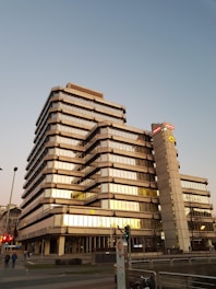 Modern office building with Middle Eastern architectural influences at sunset.