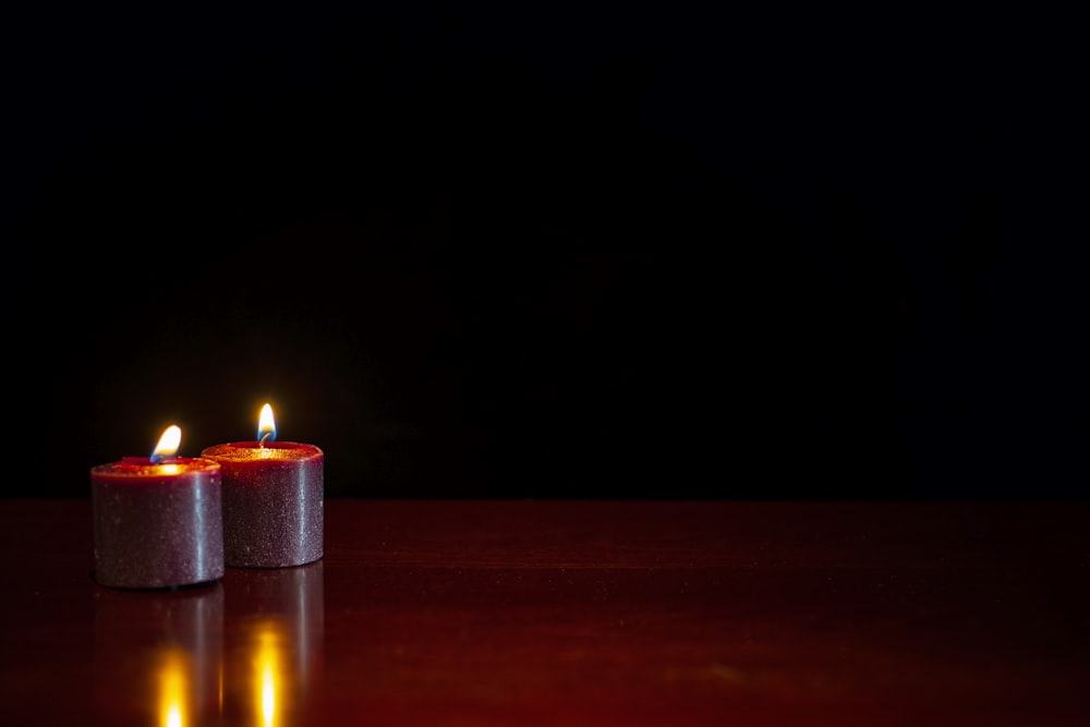 lighted candle on brown wooden table
