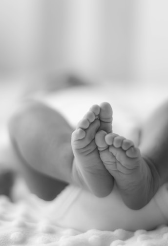 grayscale photo of babys feet