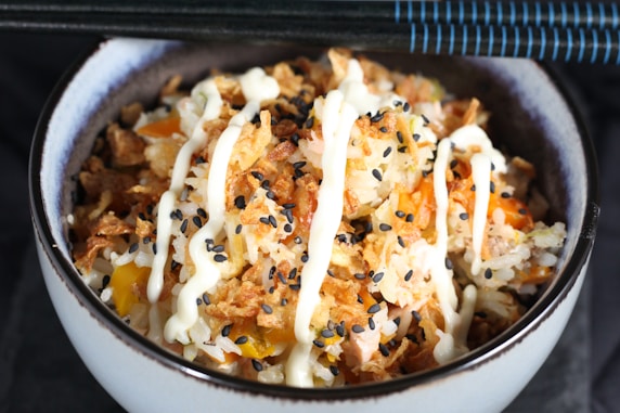 white ceramic bowl with rice and meat dish