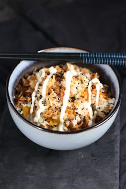 white ceramic bowl with rice and meat dish