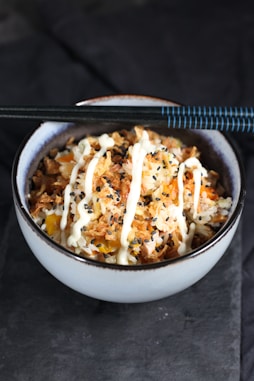 white ceramic bowl with rice and meat dish