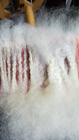 Close-up of non-woven fabric layers being laminated with precision machinery.