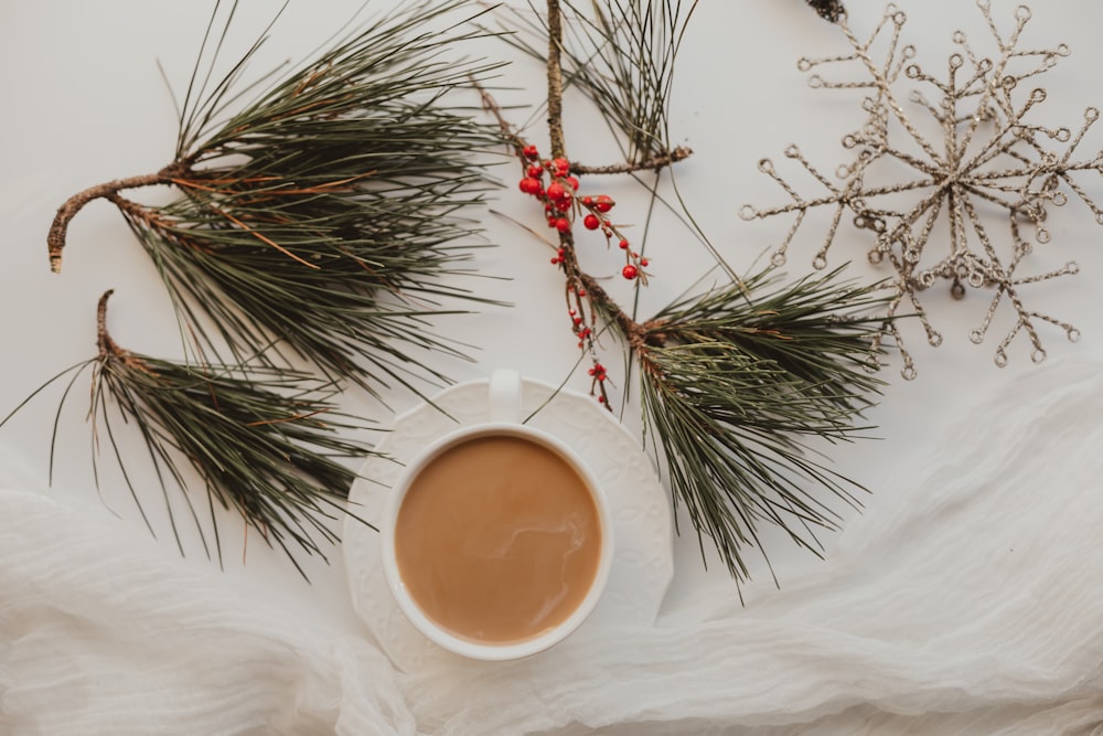 white ceramic cup with brown liquid inside