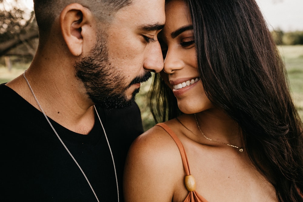 man and woman kissing during daytime