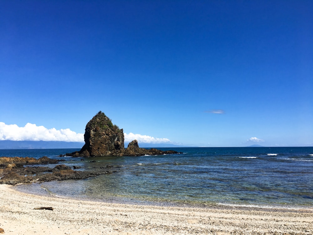 brown rock formation on sea shore during daytime